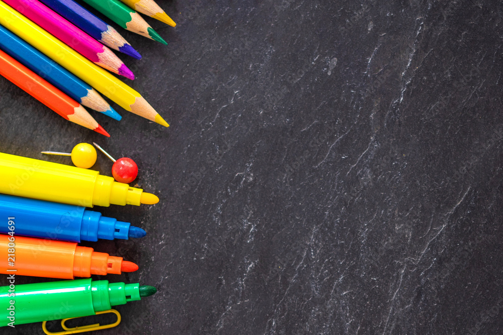 School supplies on black chalk board background, top view. Back to school and Education concept. Flat lay, copy-space School supplies on black chalk board background, top view. Back to school and Education concept. Flat lay, copy-space