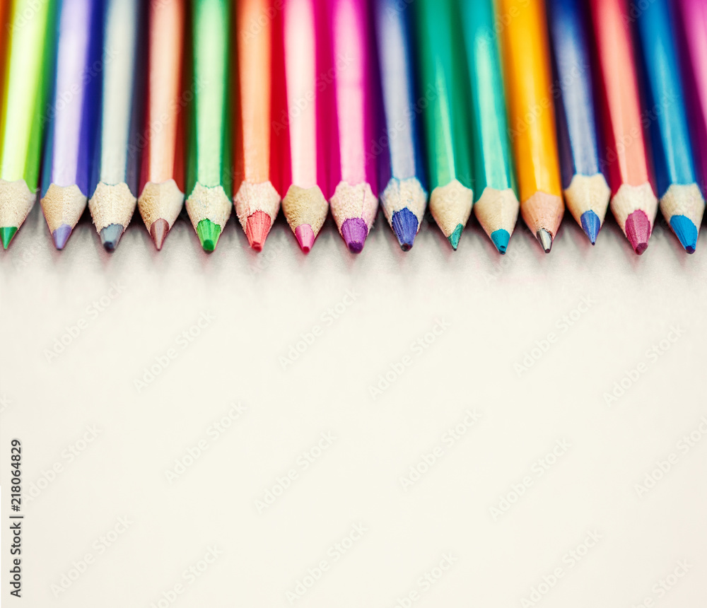 Color pencils in a row on bright background. Close up. Education, school concept.. Color pencils in a row on bright background. Close up. Education, school concept..