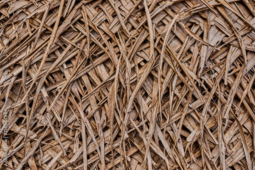 Old weathered coconut leaf roof of hut. Dried banana palm leaves
