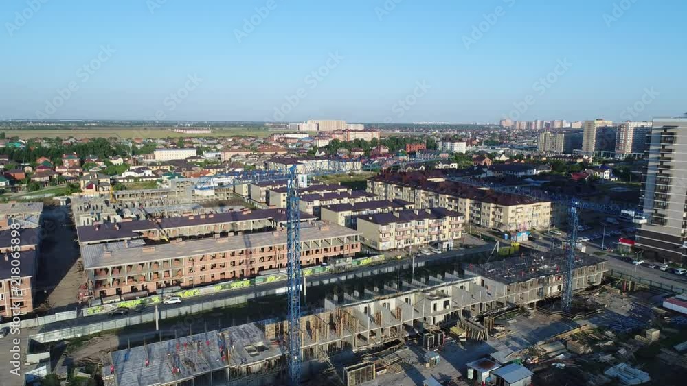 Aerial view - city and building cranes. Aerial view - city and building cranes.