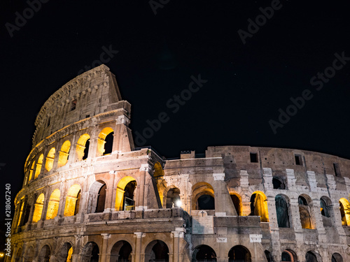 Roman colosseo by night. Ancient colosseum on black sky background.