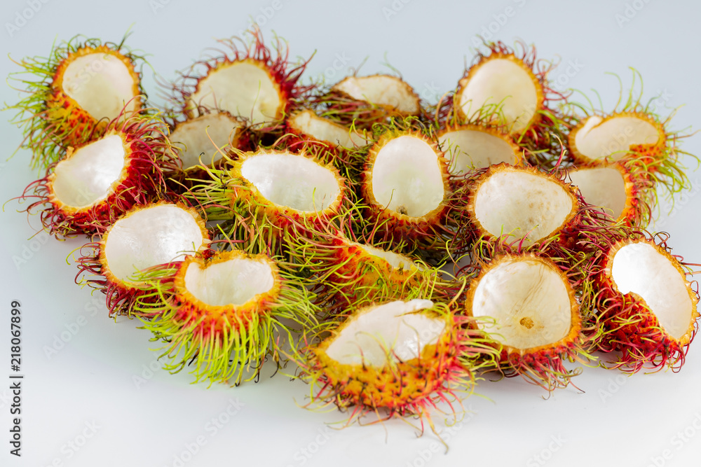 rambutan 's peel , red hairy skin fruit sweet and delicious thai famous tropical fruit on white background rambutan 's peel , red hairy skin fruit sweet and delicious thai famous tropical fruit on white background
