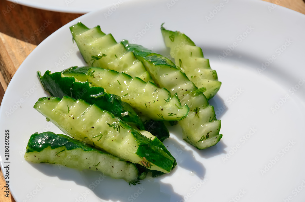 slices cucumber in a plate (beautiful shape) on white background slices cucumber in a plate (beautiful shape) on white background
