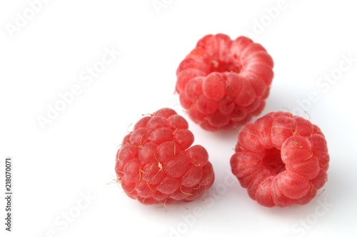 Red ripe raspberries isolated on white background.