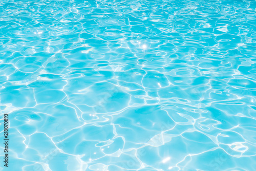 Blue and bright water in swimming pool with sun reflection  Motion of ripple water and gentle wave in pool