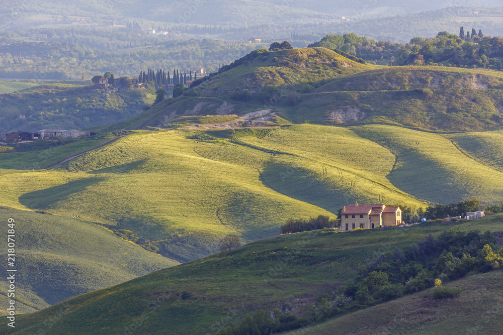 House on a hillside in a rural landscape