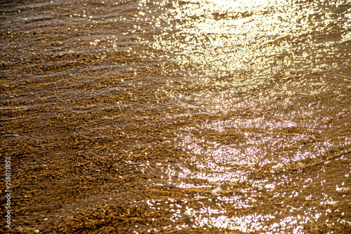 shalllow water of the sea with sun reflections photo