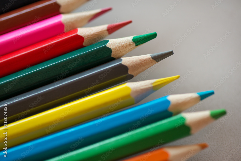 Pile of sharp coloured drawing pencils on table. Rainbow colors red, yellow, blue, green, purple. Concept of art, crafts and kids having fun Pile of sharp coloured drawing pencils on table. Rainbow colors red, yellow, blue, green, purple. Concept of art, crafts and kids having fun