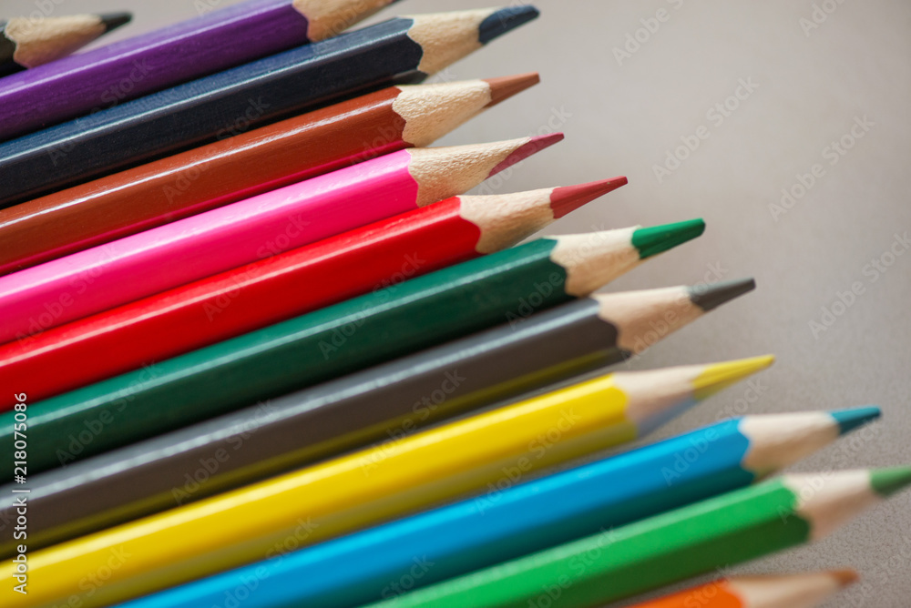 Pile of sharp coloured drawing pencils on table. Rainbow colors red, yellow, blue, green, purple. Concept of art, crafts and kids having fun Pile of sharp coloured drawing pencils on table. Rainbow colors red, yellow, blue, green, purple. Concept of art, crafts and kids having fun