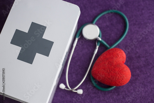 A heart monitor and a box of medicines.