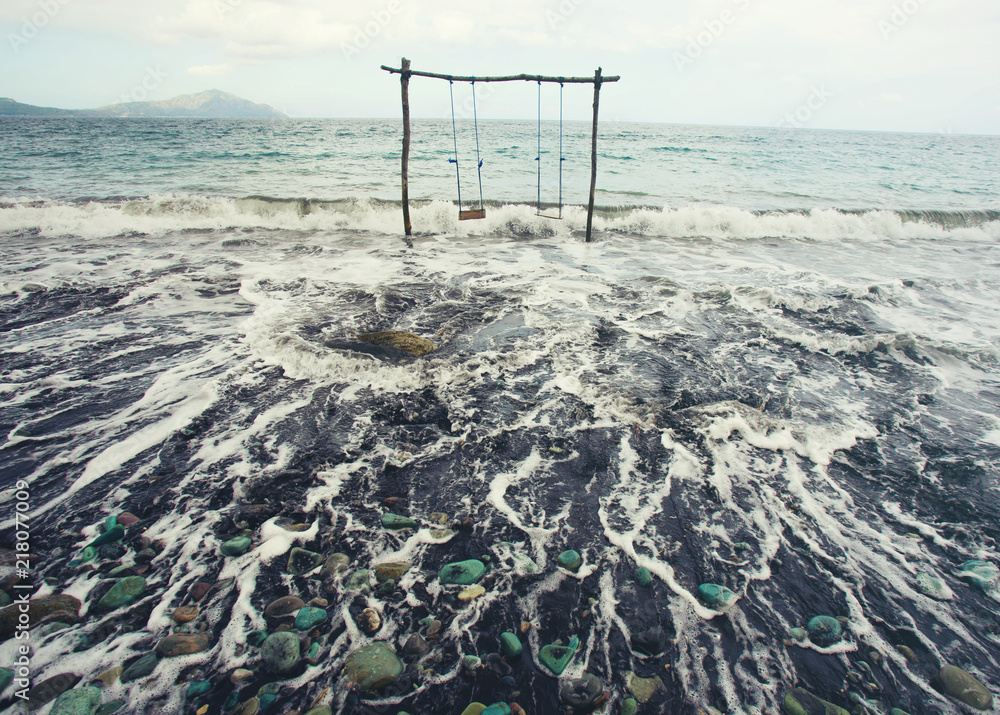 dangerous wooden swing over the sea. dangerous wooden swing over the sea.