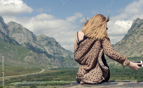 sitting girl in the mountains