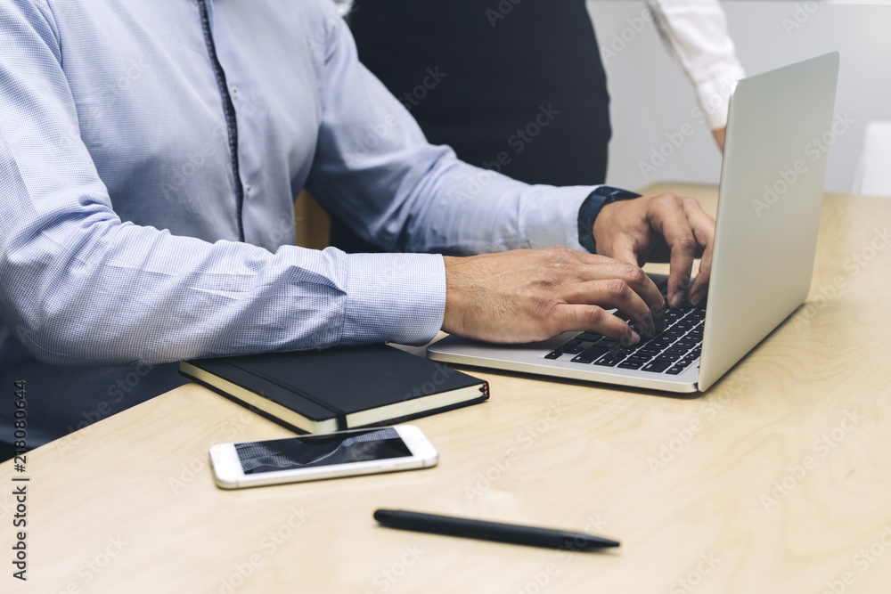 Young businessman working on laptop in modern office Young businessman working on laptop in modern office