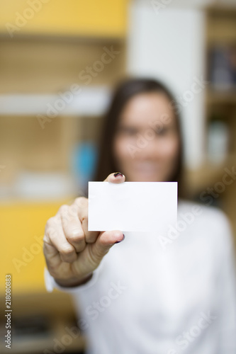 Young businesswoman holding a blank card for your message