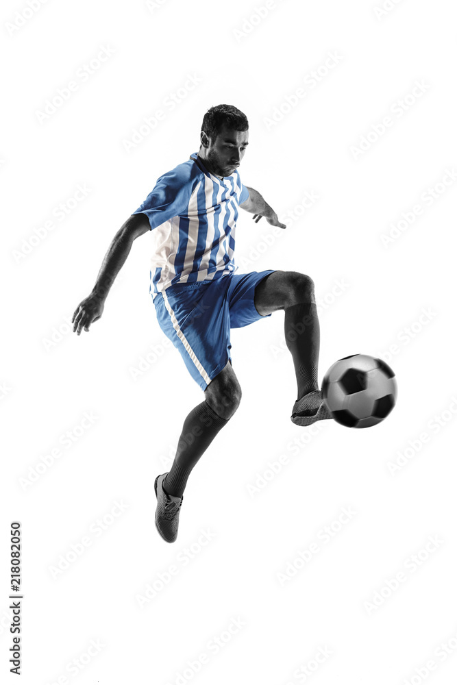 Professional football soccer player with ball isolated on white studio background