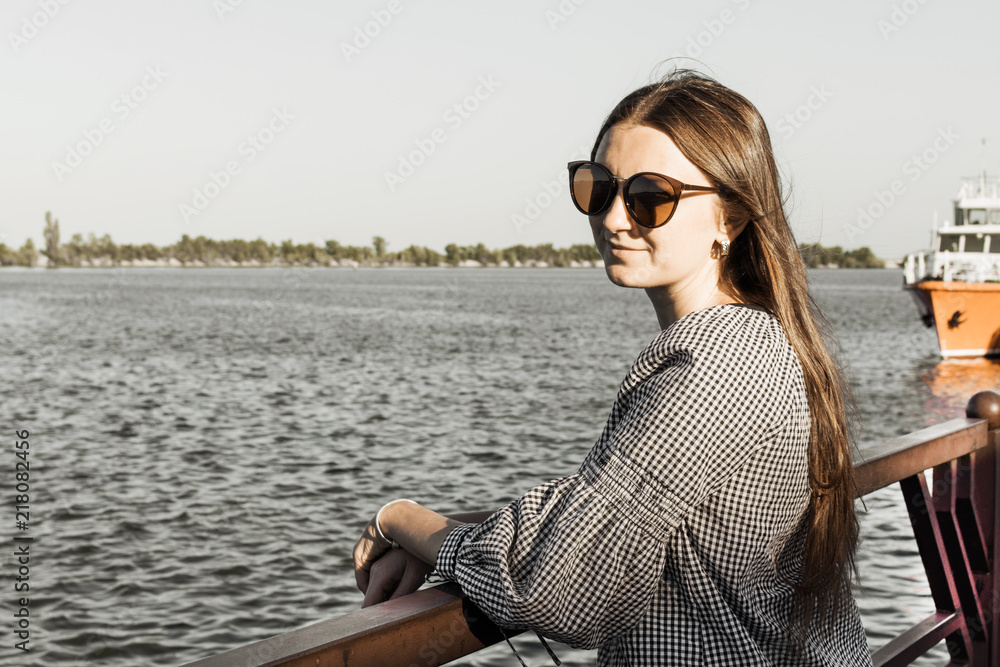 The girl admire the seascape. River harbor.