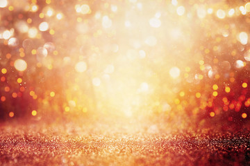 blurred abstract photo of light burst among trees and glitter golden bokeh lights.