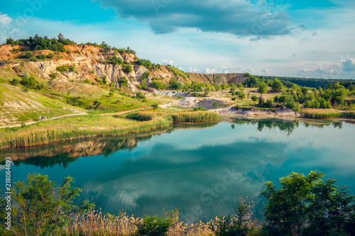 Beautiful sky reflecting on lake near hillside