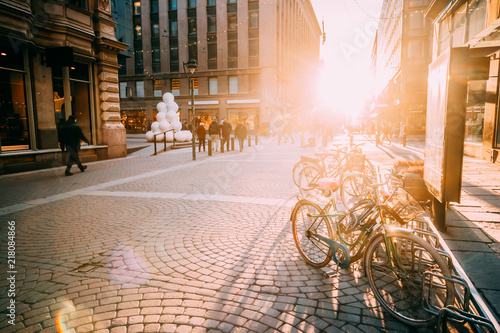 Helsinki, Finland. Bicycles Parked Near Storefronts In Kluuvikatu Street. photo