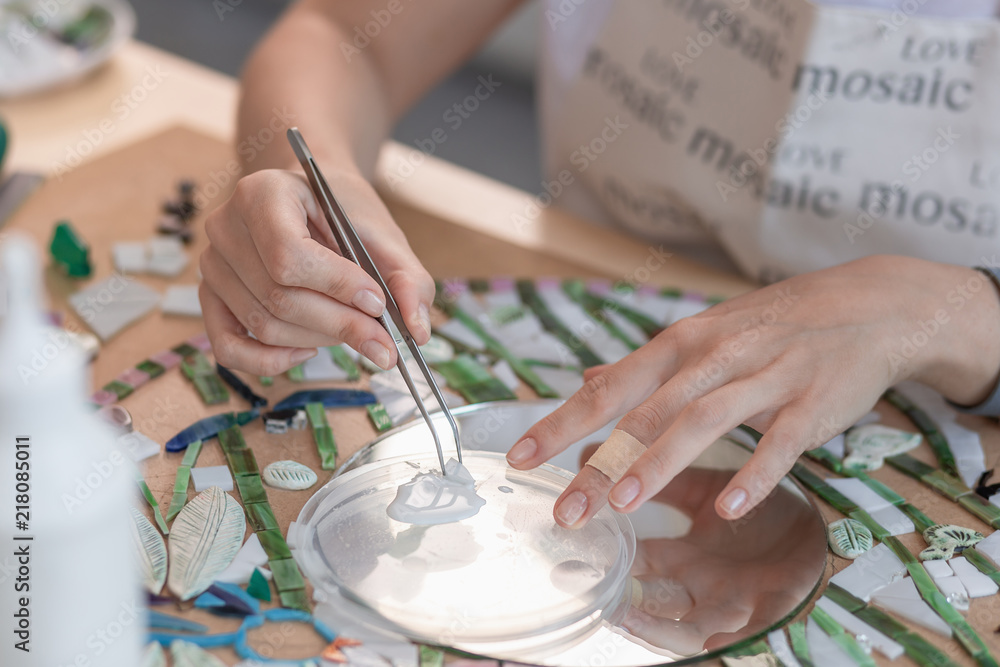 Obraz premium Hands of master working on new modern colorful mosaic. Close-up