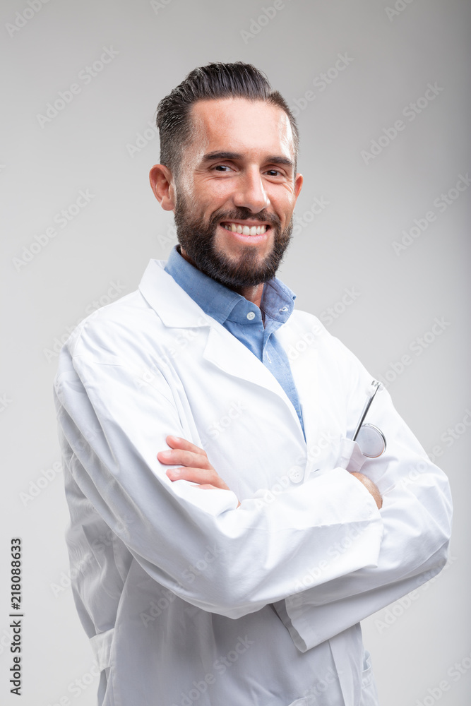 Smiling confident male doctor in a white lab coat Smiling confident male doctor in a white lab coat