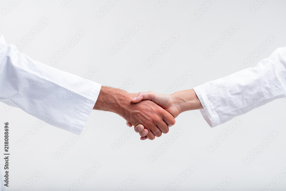 Two medical personnel shaking hands Two medical personnel shaking hands