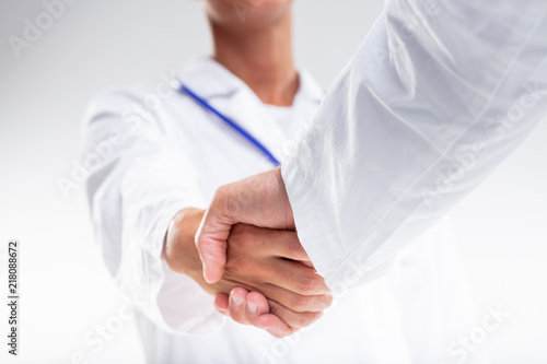 Two medical doctors shaking hands