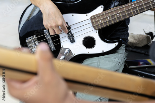 Practice your music to prepare for the show. Playing bass guitar.