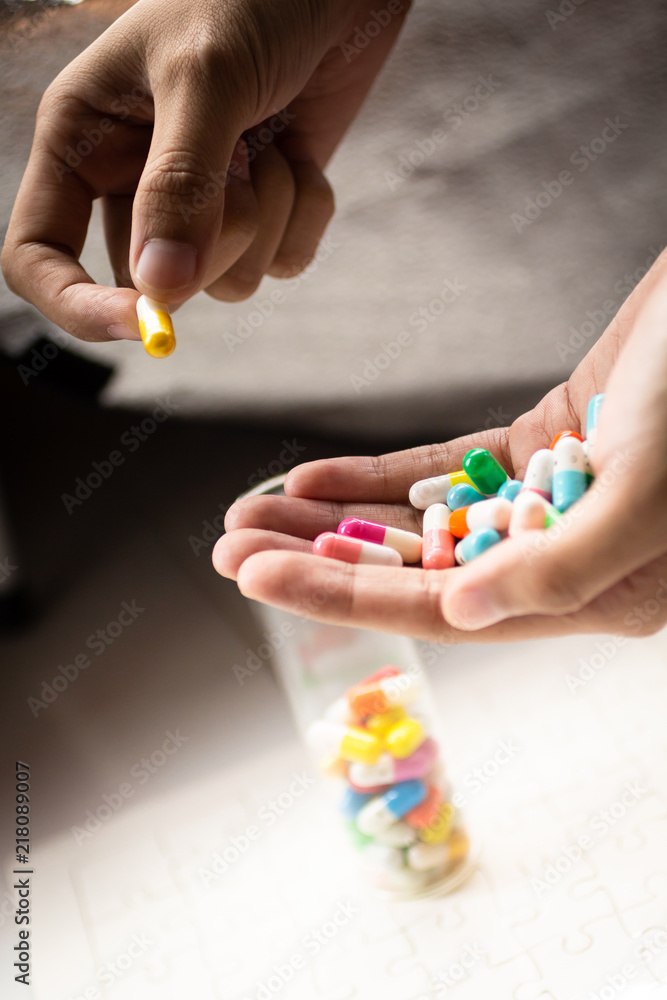 Colorful capsules tablets hold on hand. Image use for health care concept Colorful capsules tablets hold on hand. Image use for health care concept