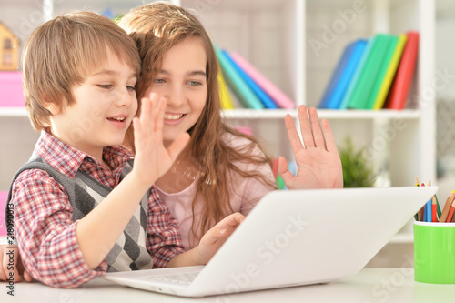 Portrait of a boy and girl using laptop
