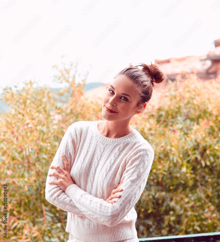 Pretty smiling beautiful young woman in white sweater and underwear, standing on balcony. Tuscany, Italy. Small depth of field. Pretty smiling beautiful young woman in white sweater and underwear, standing on balcony. Tuscany, Italy. Small depth of field.
