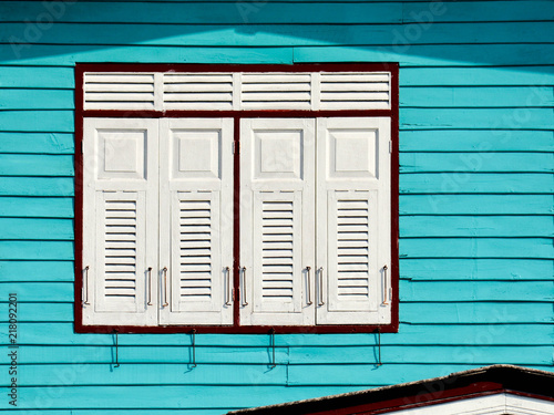 white wood window at blue house