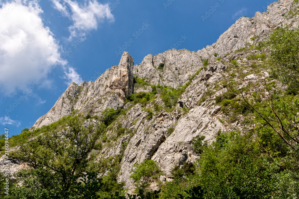 Beautiful mountain peak with blue sky and clouds in Turda gorge, Romania