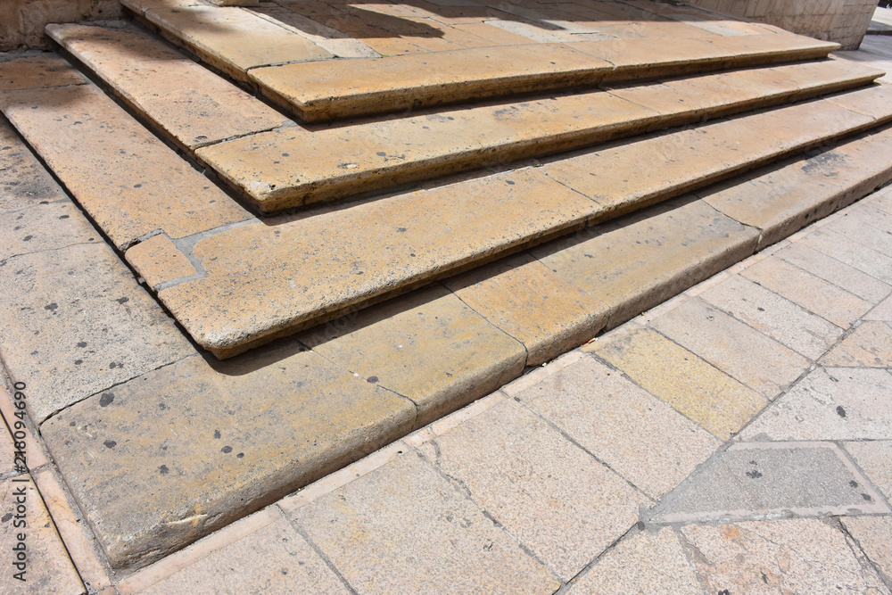 Italy, Puglia region, Altamura,  Cathedral of Santa Maria Assunta, gate and sculptures of the main façade. Medieval steps at the entrance