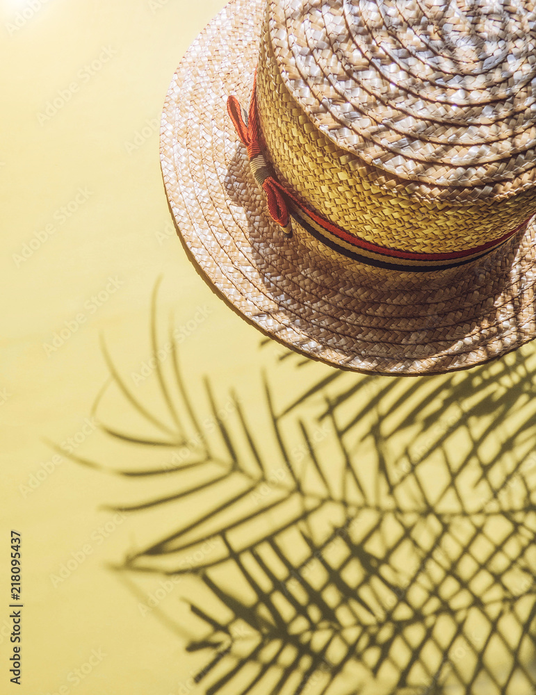 Fototapeta premium Holiday, vacation tropical beach from above - palm tree leaves and a straw hat