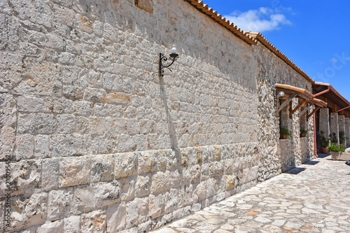 Italy, Puglia region, view and detail of typical fortified farmhouses spread in the high Murgia area with wells, trees, meadows,