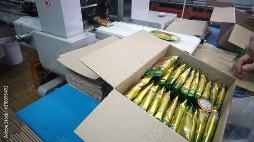 Packing ice cream in cardboard boxes using human work