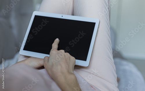 Woman relaxing reading on the tablet computer 