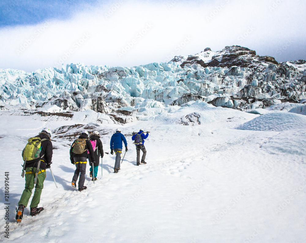 People trekking up glacier
