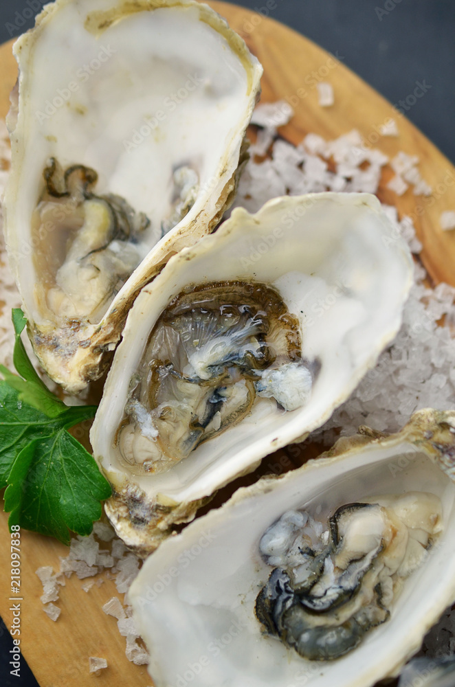 Fresh oysters platter with sauce and lemon
Fresh oysters platter with sauce and lemon