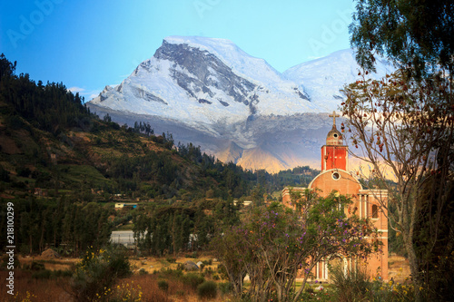 HUASCARAN PEAK MOUNTAIN SEEN TROUGH ROCK MOUNTAINS IN A SUNNY DAY IN HUARAZ, PERU.