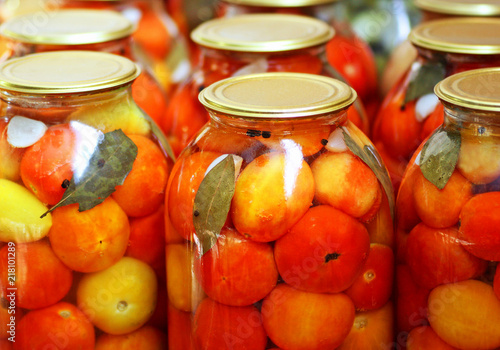 Pickled tomatoes in jars. © NataliaL