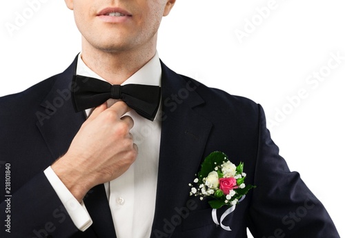 Closeup of Groom Checking the Bow Tie