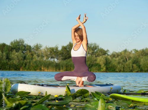 SUP young beautiful girl yoga meditation