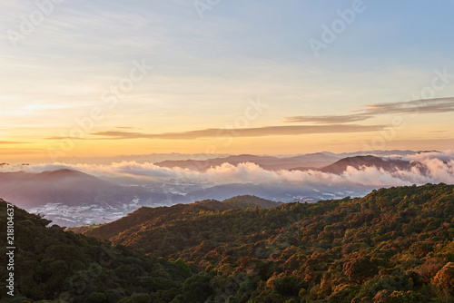 Landscape with peaks covered by fog and clouds. Natural mountain background.