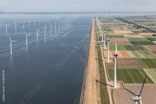 Aerial view Dutch agricultural landscape with big offshore wind turbines along the coast photo