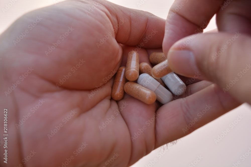 Mano mostrando un cóctel de diferentes medicamentos para el tratamiento de enfermedades como el VIH o simplemente como complementos alimenticios o adelgazamiento Mano mostrando un cóctel de diferentes medicamentos para el tratamiento de enfermedades como el VIH o simplemente como complementos alimenticios o adelgazamiento