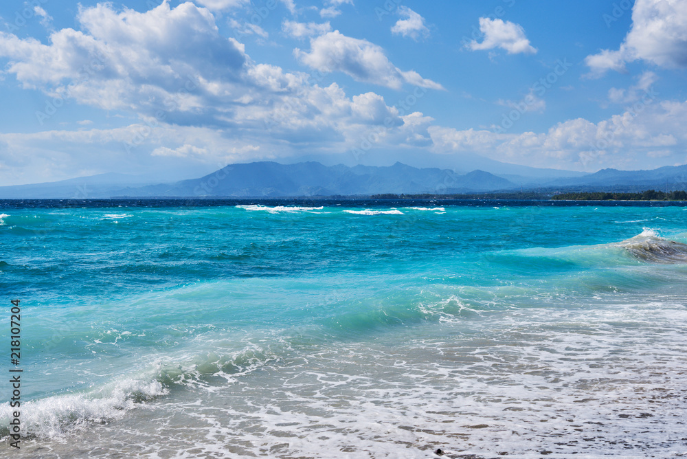 Azure beach with clear water and mountains on the background at sunny day. Tropical islands. Sea view amazing nature background. Paradise nature, sea water, summer on the tropical beach.