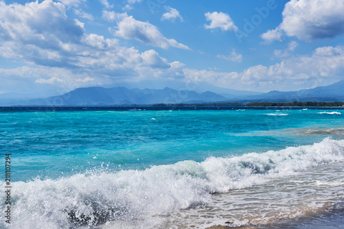 Azure beach with clear water and mountains on the background at sunny day. Tropical islands. Sea view amazing nature background. Paradise nature, sea water, summer on the tropical beach.