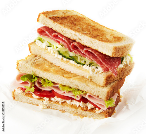 Tasty sandwich with ham, lettuce, tomatoes